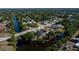 Aerial view of a home backing onto a canal in a quiet neighborhood surrounded by lush greenery at 7225 Sea Mist Dr, Port Charlotte, FL 33981