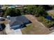 Back aerial view showing a well maintained home with a shed and canal with mature landscaping at 7225 Sea Mist Dr, Port Charlotte, FL 33981