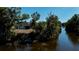 Scenic aerial view of the property backing onto a tranquil waterway with lush greenery and mature trees at 7225 Sea Mist Dr, Port Charlotte, FL 33981