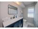 Bathroom featuring vanity, toilet, window and tile floors at 7225 Sea Mist Dr, Port Charlotte, FL 33981