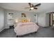 Spacious bedroom with a ceiling fan, two windows, and closet storage at 7225 Sea Mist Dr, Port Charlotte, FL 33981