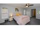 Spacious bedroom with a ceiling fan, two windows, and closet storage at 7225 Sea Mist Dr, Port Charlotte, FL 33981