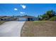 Charming single-story home featuring an attached two-car garage and a well-manicured lawn on a sunny day at 7225 Sea Mist Dr, Port Charlotte, FL 33981