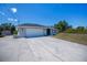 Well-maintained home with a two-car garage, modern lighting, and ample parking space at 7225 Sea Mist Dr, Port Charlotte, FL 33981