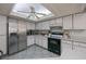 Bright kitchen with stainless steel appliances, abundant cabinetry, and a skylight for natural light at 7225 Sea Mist Dr, Port Charlotte, FL 33981