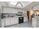 Well-equipped kitchen with white cabinets, modern appliances, and a skylight that provides ample natural light at 7225 Sea Mist Dr, Port Charlotte, FL 33981