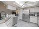 Functional kitchen featuring stainless steel appliances, ample cabinet space, and a bright skylight at 7225 Sea Mist Dr, Port Charlotte, FL 33981
