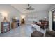 Bright living room features tile floors, vaulted ceiling, and a comfortable seating area with a leather sofa at 7225 Sea Mist Dr, Port Charlotte, FL 33981