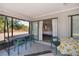 The covered patio provides access to interior rooms, features a dining area and views of the backyard at 7225 Sea Mist Dr, Port Charlotte, FL 33981