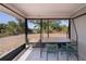 Screened in patio features views of the yard and surrounding landscape with table and chairs at 7225 Sea Mist Dr, Port Charlotte, FL 33981