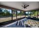 Enclosed patio featuring tile floors, ceiling fan, and views of the surrounding landscape at 7225 Sea Mist Dr, Port Charlotte, FL 33981
