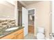 Bathroom featuring a vanity, toilet, and shower with glass doors at 8172 Trionfo Ave, North Port, FL 34287