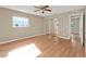 Bright bedroom with sliding closet doors and wood-look flooring at 8172 Trionfo Ave, North Port, FL 34287