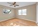 Well-lit bedroom featuring wood-look flooring and two windows for ample natural light at 8172 Trionfo Ave, North Port, FL 34287