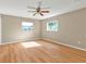 Spacious bedroom with a ceiling fan and wood-look flooring with lots of light at 8172 Trionfo Ave, North Port, FL 34287