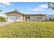 A quaint single-story home with a manicured lawn and an attached garage at 8172 Trionfo Ave, North Port, FL 34287