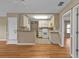 Open-concept kitchen featuring white cabinets, appliances, and a breakfast bar at 8172 Trionfo Ave, North Port, FL 34287