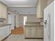 View of the kitchen with white cabinets and appliances, looking out into the dining and living rooms at 8172 Trionfo Ave, North Port, FL 34287