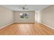 Light-filled living room featuring gleaming hardwood floors and a ceiling fan at 8172 Trionfo Ave, North Port, FL 34287