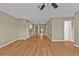 Open living space with wood-look flooring, a ceiling fan, and versatile layout options at 8172 Trionfo Ave, North Port, FL 34287