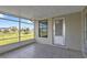 Screened in lanai with tile floor and a view of the backyard with door to the outside at 8172 Trionfo Ave, North Port, FL 34287
