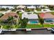 Overhead view featuring a screened-in pool, private boat dock, and meticulously maintained backyard at 859 Napoli Ln, Punta Gorda, FL 33950