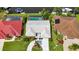 Aerial view of home with screened-in pool, lush landscaping, and private boat dock at 859 Napoli Ln, Punta Gorda, FL 33950