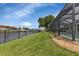 Spacious backyard featuring lush grass, landscaping, and a view of the canal at 859 Napoli Ln, Punta Gorda, FL 33950