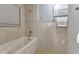 Relaxing bathroom showcasing a tiled soaking tub, decorative accents, and a serene ambiance at 859 Napoli Ln, Punta Gorda, FL 33950