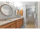 Bathroom featuring double sinks, wooden cabinets and a soaking tub at 859 Napoli Ln, Punta Gorda, FL 33950