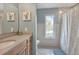 Bathroom features vanity, sink, and walk in shower with tile surround at 859 Napoli Ln, Punta Gorda, FL 33950