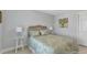 Bright bedroom features a queen bed, bedside tables and a floral-themed color palette at 859 Napoli Ln, Punta Gorda, FL 33950