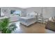 Sunlit bedroom featuring a cozy bed, bright windows, and tile flooring at 859 Napoli Ln, Punta Gorda, FL 33950