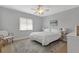 Cozy bedroom with a large window, ceiling fan, and an area rug at 859 Napoli Ln, Punta Gorda, FL 33950