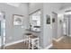 Bright breakfast bar with two stools that opens to the kitchen, artwork, and tile flooring at 859 Napoli Ln, Punta Gorda, FL 33950