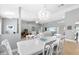 Open-concept dining room featuring tile flooring, modern chandelier, and ample natural light at 859 Napoli Ln, Punta Gorda, FL 33950