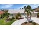 Charming single-story home with a well-manicured lawn and elegant circular driveway at 859 Napoli Ln, Punta Gorda, FL 33950