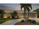 Charming home exterior at dusk with well-maintained landscaping and welcoming curb appeal at 859 Napoli Ln, Punta Gorda, FL 33950