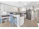 Bright kitchen featuring a breakfast bar, stainless steel appliances, and stylish countertops at 859 Napoli Ln, Punta Gorda, FL 33950