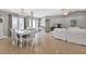 Open-concept living area with tile floors, modern lighting, and a seamless flow to dining at 859 Napoli Ln, Punta Gorda, FL 33950