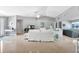 Bright and spacious living area with tile flooring, ceiling fan, and multiple seating areas at 859 Napoli Ln, Punta Gorda, FL 33950