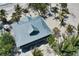 Aerial shot showcasing the metal roof of beach home surrounded by lush tropical vegetation at 8754 King St, Placida, FL 33946
