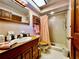 Traditional bathroom featuring a wood vanity, skylight, and tiled shower at 8754 King St, Placida, FL 33946