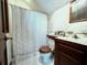 Bathroom featuring tiled floor, a unique wood toilet seat and a shower curtain at 8754 King St, Placida, FL 33946