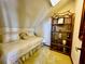 Attic bedroom featuring slanted ceilings, neutral colors and a shelving unit at 8754 King St, Placida, FL 33946