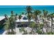 Beach house boasts a metal roof and sits among tropical foliage and swaying palm trees at 8754 King St, Placida, FL 33946