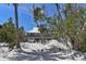 Beach home on stilts amid sandy terrain and tropical vegetation with ocean view at 8754 King St, Placida, FL 33946