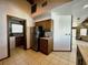 Bright kitchen with stainless steel refrigerator, wood cabinets, and tiled flooring at 8754 King St, Placida, FL 33946