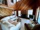 Bright living room with tile floors, wood ceiling, fireplace, and large windows at 8754 King St, Placida, FL 33946
