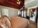 Inviting primary bedroom with wood ceiling, access to a balcony, and a cozy atmosphere at 8754 King St, Placida, FL 33946